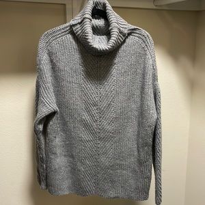 woman’s oversize turtleneck drop shoulder sweater
